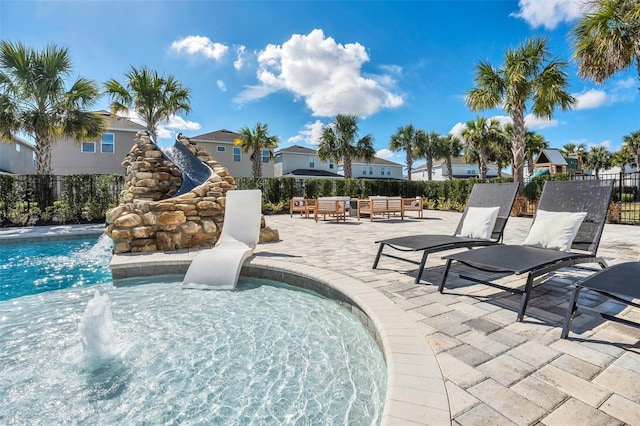 view of pool with a patio, an outdoor hangout area, fence, and a fenced in pool