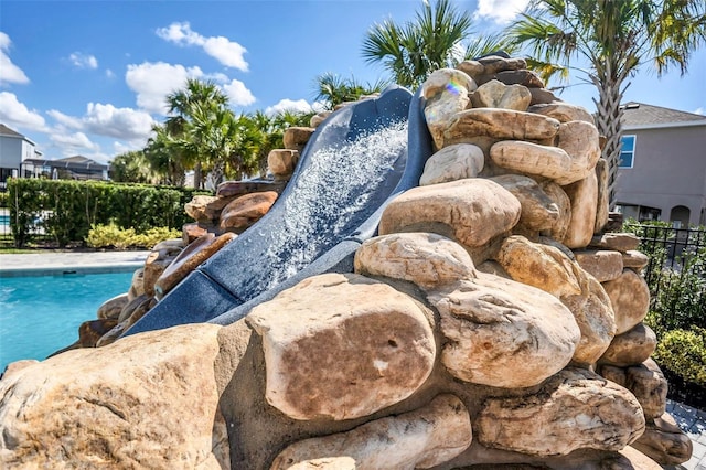 exterior details with fence and a pool