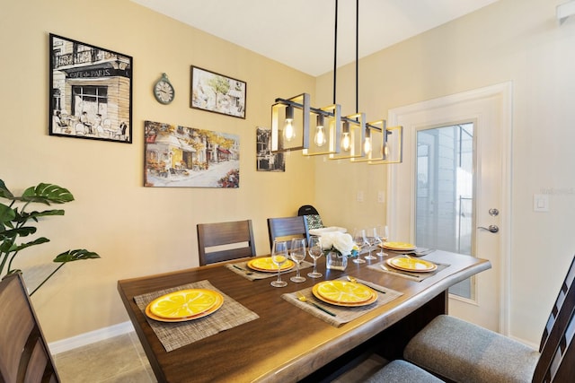 tiled dining area featuring a chandelier