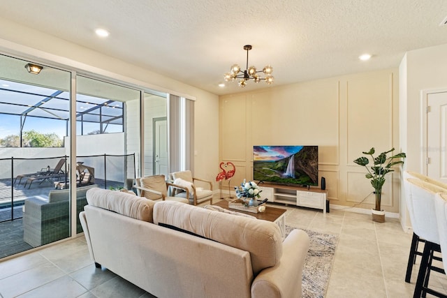 tiled living room featuring an inviting chandelier and a textured ceiling