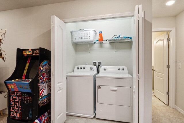 7143 Oakmoss Loop, Davenport, FL 33837 - washroom featuring washing machine and dryer, baseboards, and light carpet