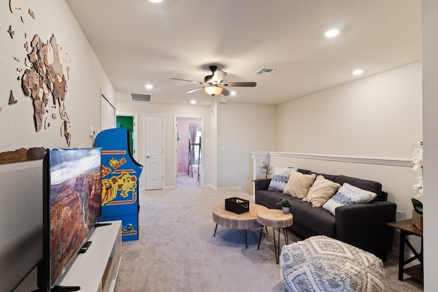 carpeted living room with ceiling fan