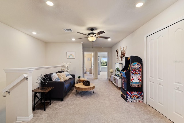 sitting room with light colored carpet and ceiling fan