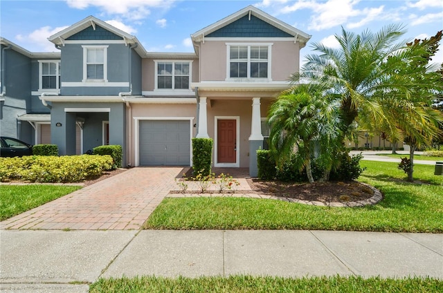 view of front of property with a garage and a front yard