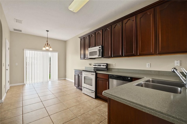 kitchen with sink, decorative light fixtures, dark brown cabinets, light tile patterned floors, and appliances with stainless steel finishes