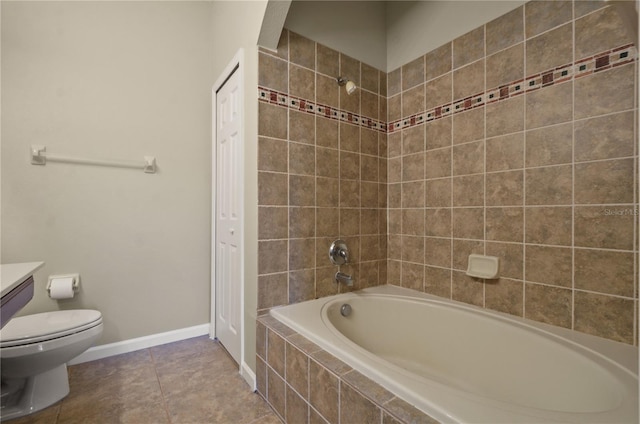 full bathroom featuring tile patterned flooring, vanity, toilet, and tiled shower / bath