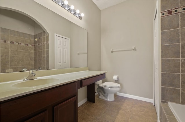 full bathroom with tile patterned flooring, vanity, tiled shower / bath, and toilet