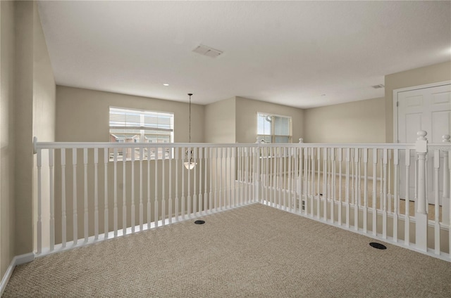 carpeted empty room featuring a healthy amount of sunlight