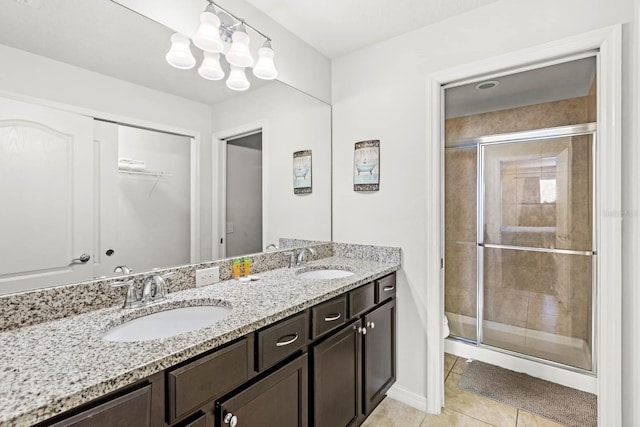 bathroom with tile patterned flooring, vanity, and an enclosed shower