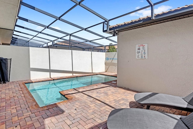 view of pool featuring a patio area and glass enclosure