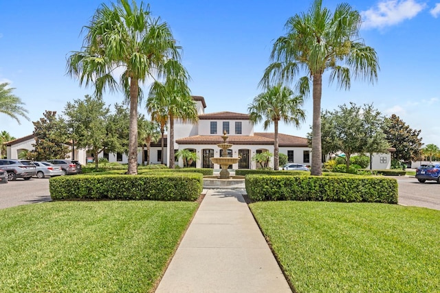 mediterranean / spanish house with a front yard