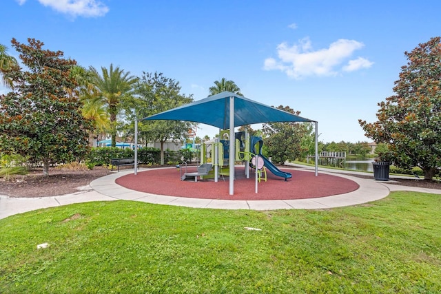 view of playground with a water view and a yard