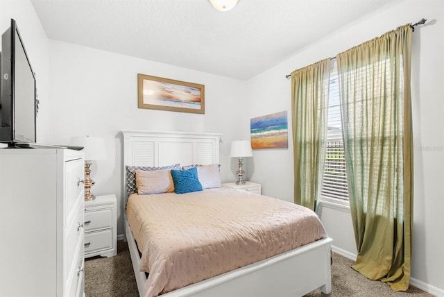 carpeted bedroom featuring a textured ceiling