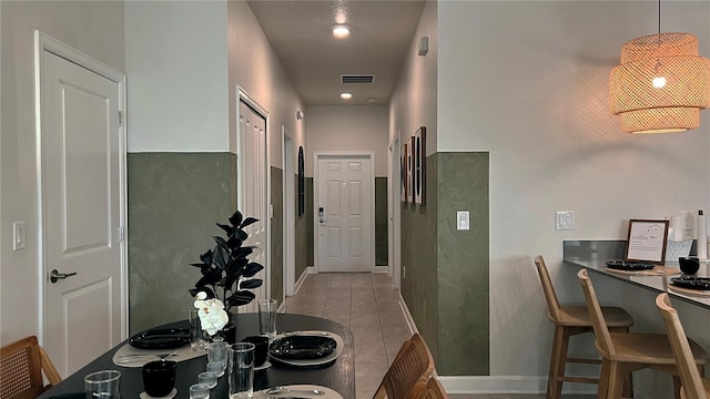 hall with light tile patterned floors