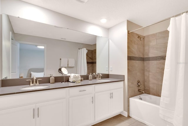 bathroom featuring dual vanity, shower / tub combo, and tile patterned flooring