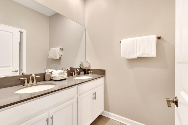 bathroom featuring tile patterned flooring and dual bowl vanity