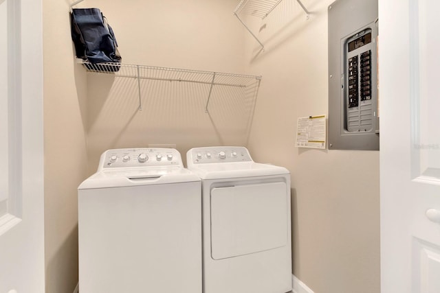 clothes washing area with washer and dryer and electric panel