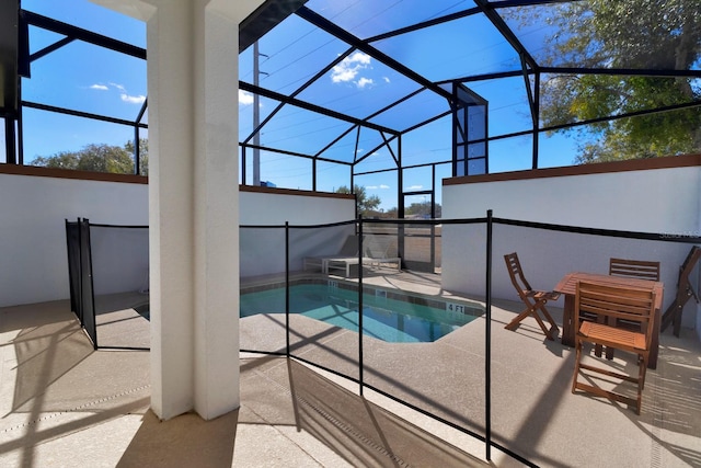 view of pool featuring a patio and glass enclosure