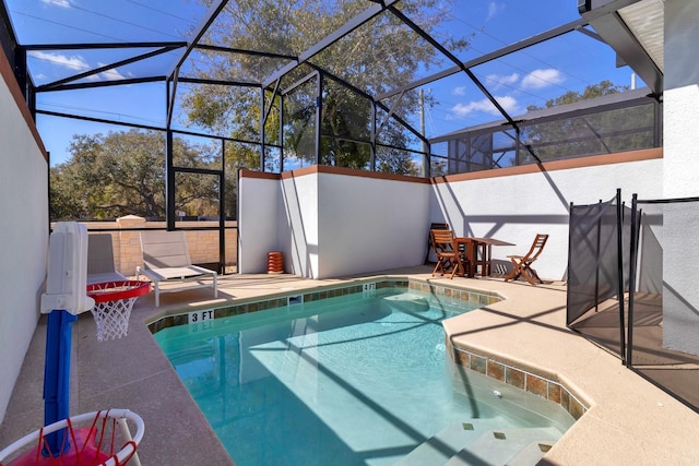 view of swimming pool featuring a patio area, a lanai, and a hot tub