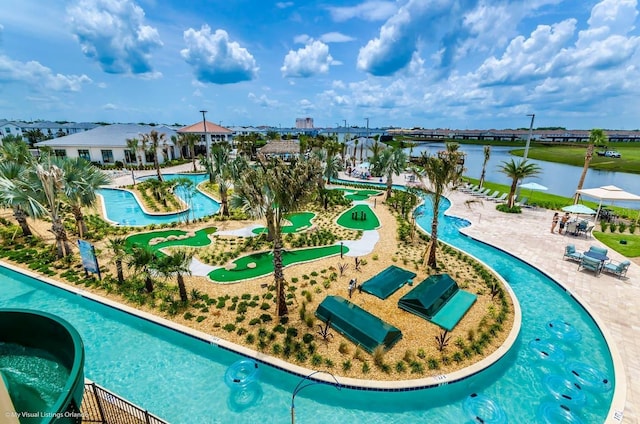 view of pool featuring a patio and a water view