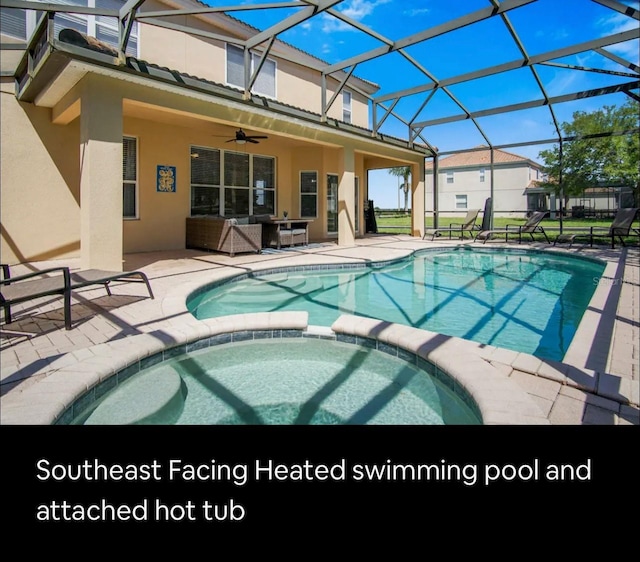 view of pool featuring an in ground hot tub, an outdoor living space, ceiling fan, glass enclosure, and a patio area