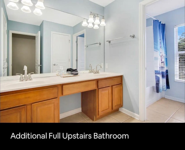 bathroom featuring shower / bath combo with shower curtain, tile patterned flooring, and vanity