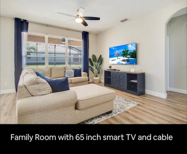 living room featuring hardwood / wood-style flooring and ceiling fan