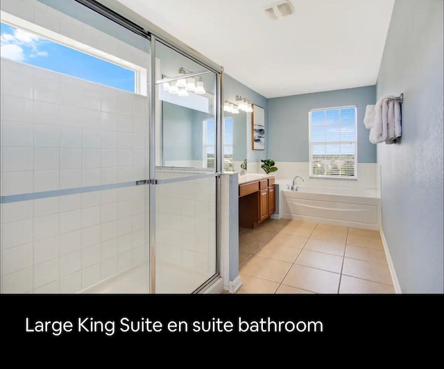 bathroom with shower with separate bathtub, vanity, and tile patterned floors