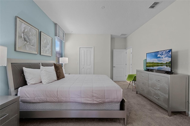 bedroom featuring a closet and light carpet