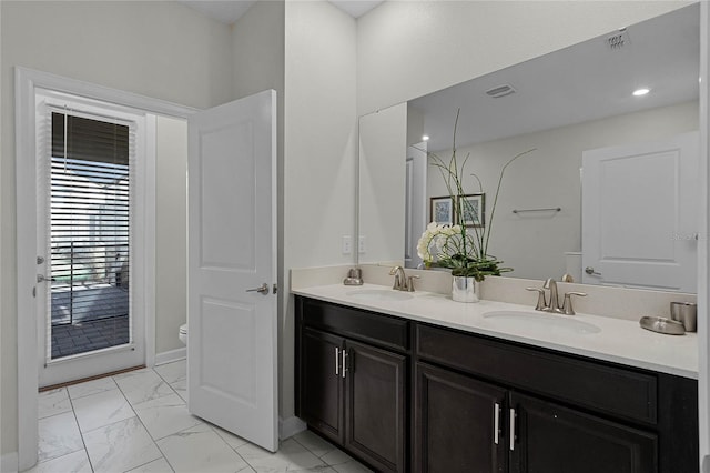 bathroom with toilet and vanity