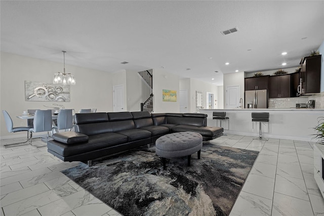 living room with sink and an inviting chandelier