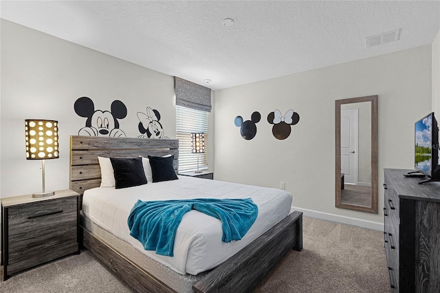 bedroom with a textured ceiling and light carpet