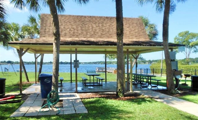 view of home's community with a gazebo, a water view, and a yard