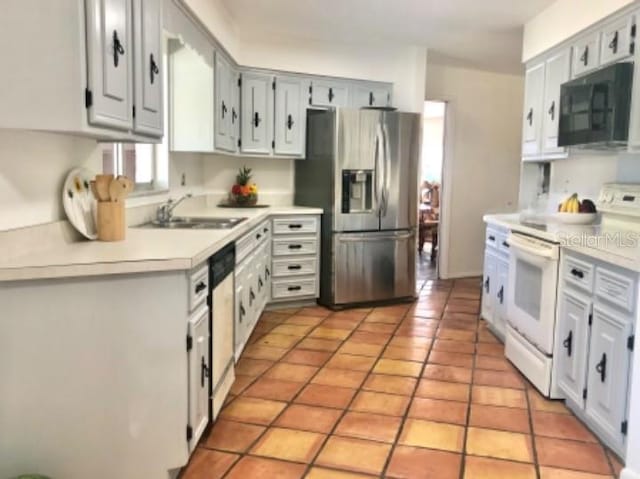 kitchen featuring stainless steel appliances, sink, and light tile patterned floors