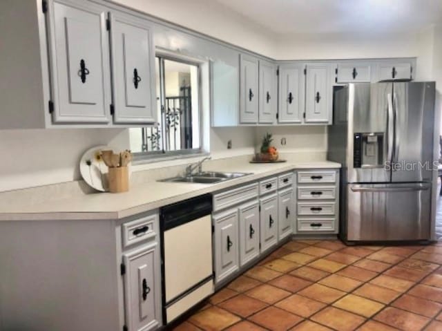 kitchen with tile patterned flooring, stainless steel refrigerator with ice dispenser, dishwasher, and sink