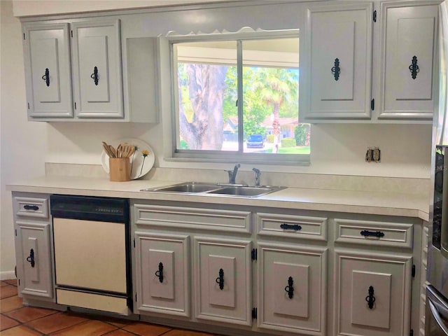 kitchen with white cabinetry, tile patterned flooring, dishwasher, and sink