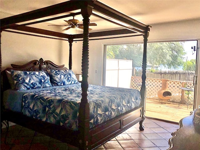 tiled bedroom featuring multiple windows, beam ceiling, and ceiling fan