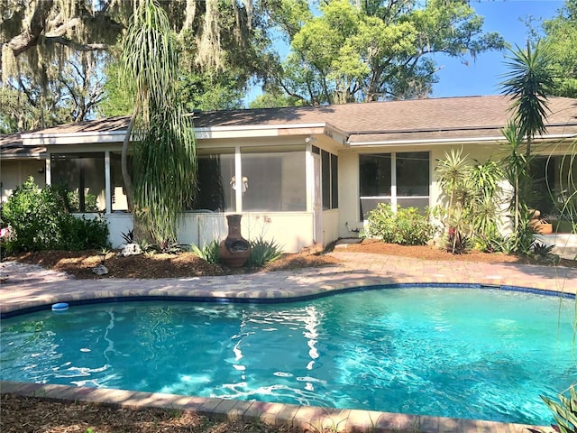 view of pool featuring a sunroom