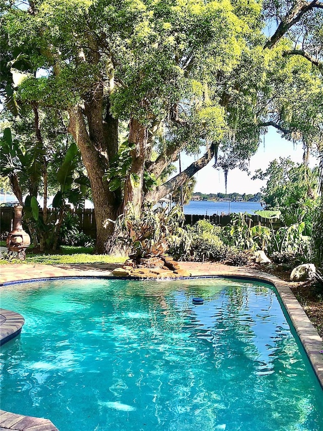 view of pool with a water view