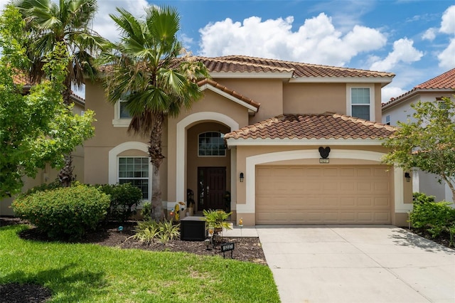 mediterranean / spanish-style house with a garage