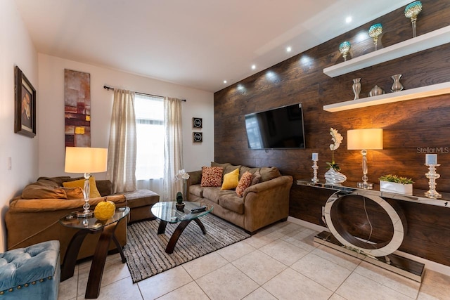 tiled living room featuring wood walls