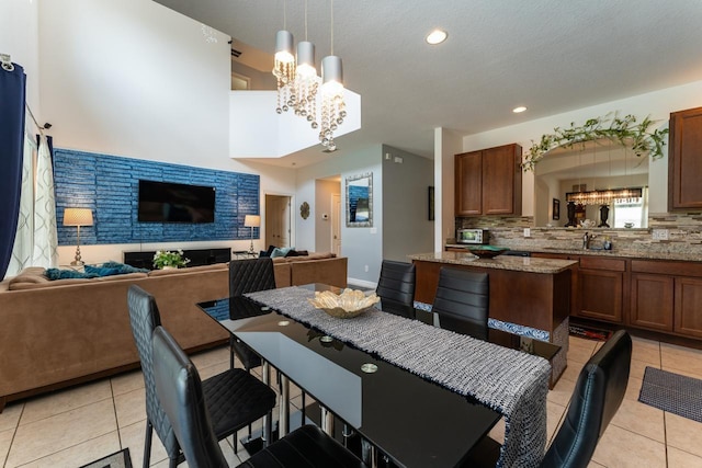 dining room featuring light tile patterned floors, sink, and a chandelier