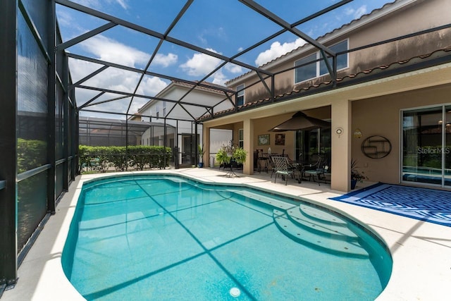 view of swimming pool with a patio and glass enclosure