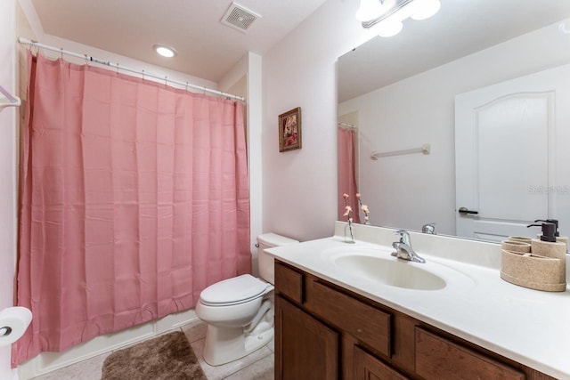 bathroom with toilet, tile patterned floors, and vanity