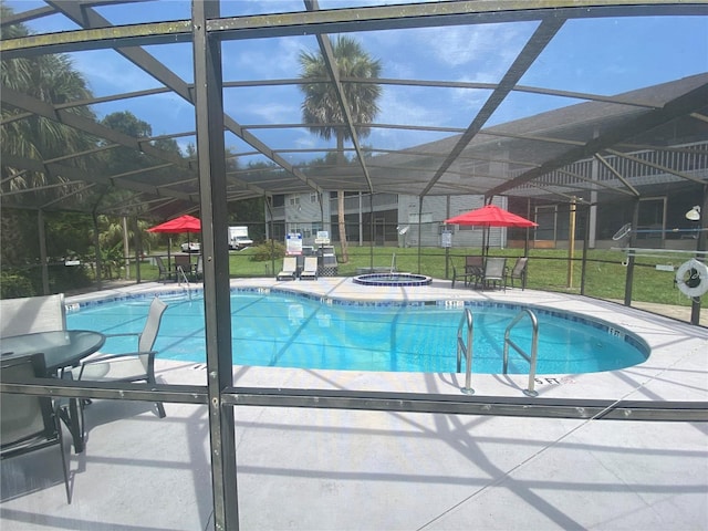 view of pool with glass enclosure and a lawn