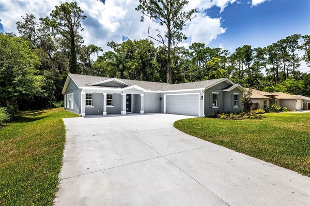 ranch-style home featuring a garage and a front lawn