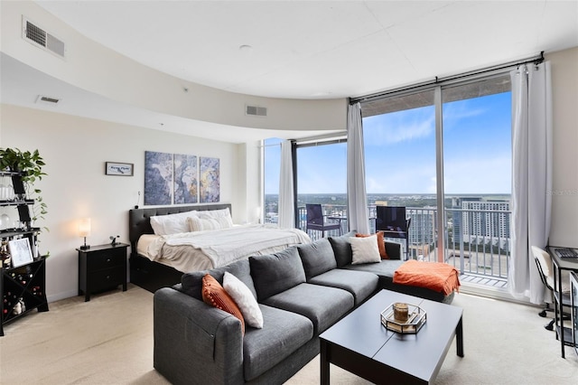 carpeted bedroom featuring expansive windows and access to outside