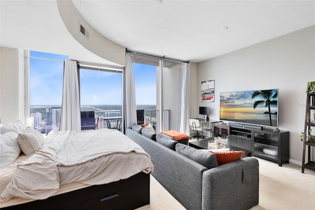 bedroom with light colored carpet and floor to ceiling windows