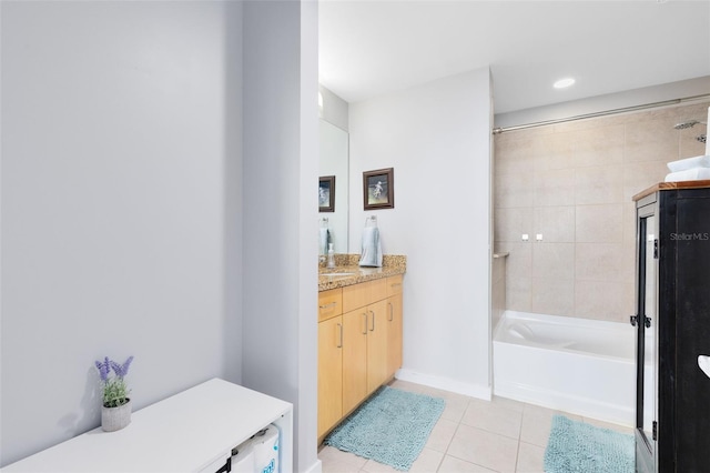 bathroom featuring tile patterned flooring, vanity, and tiled shower / bath combo