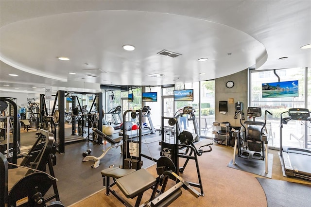 gym with a wall of windows